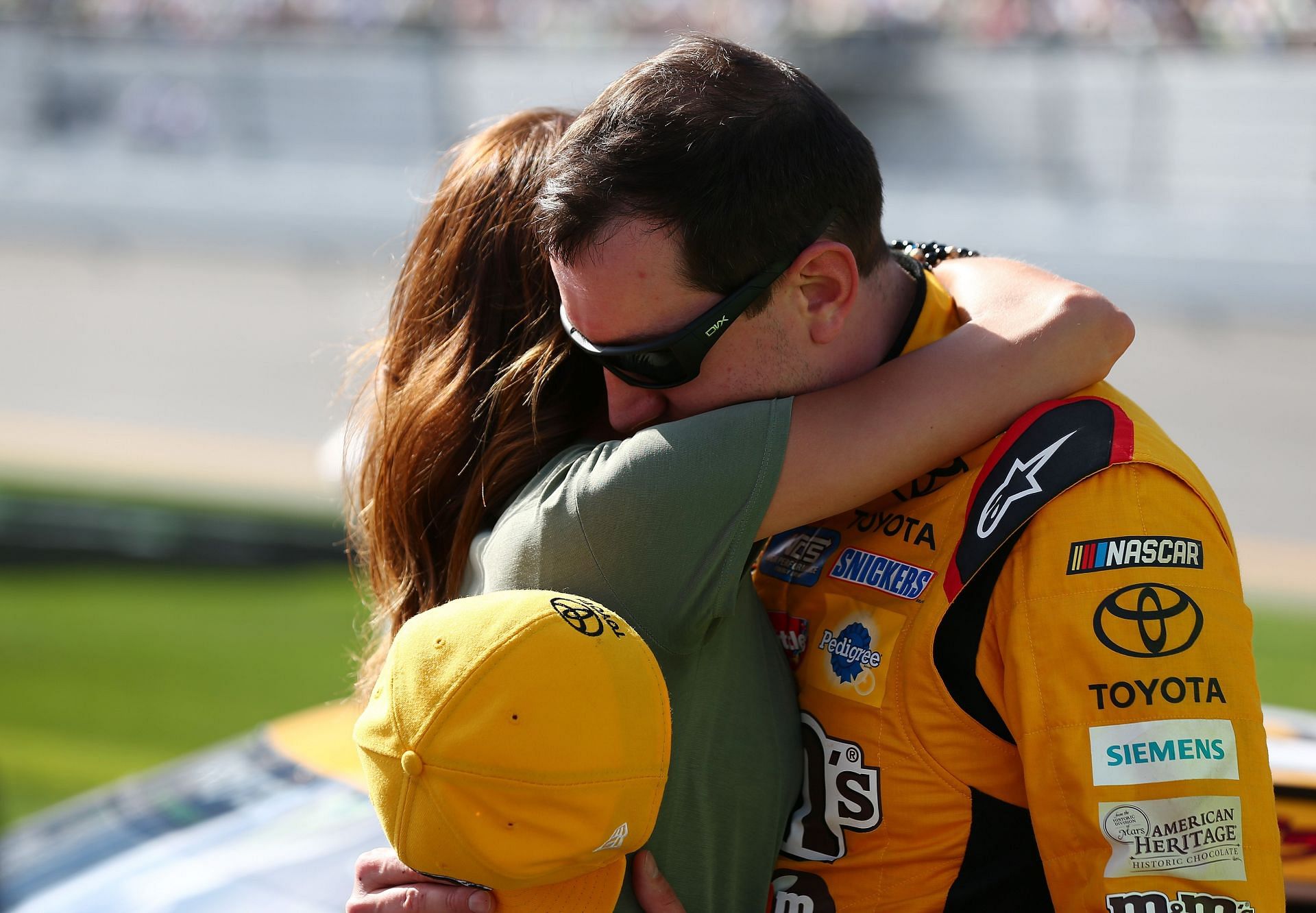 Kyle Busch, driver of the #18 M&M's Toyota, hugs his wife, Samantha, before the Monster Energy NASCAR Cup Series Advance Auto Parts Clash at Daytona International Speedway on February 11, 2018 - Source: Getty